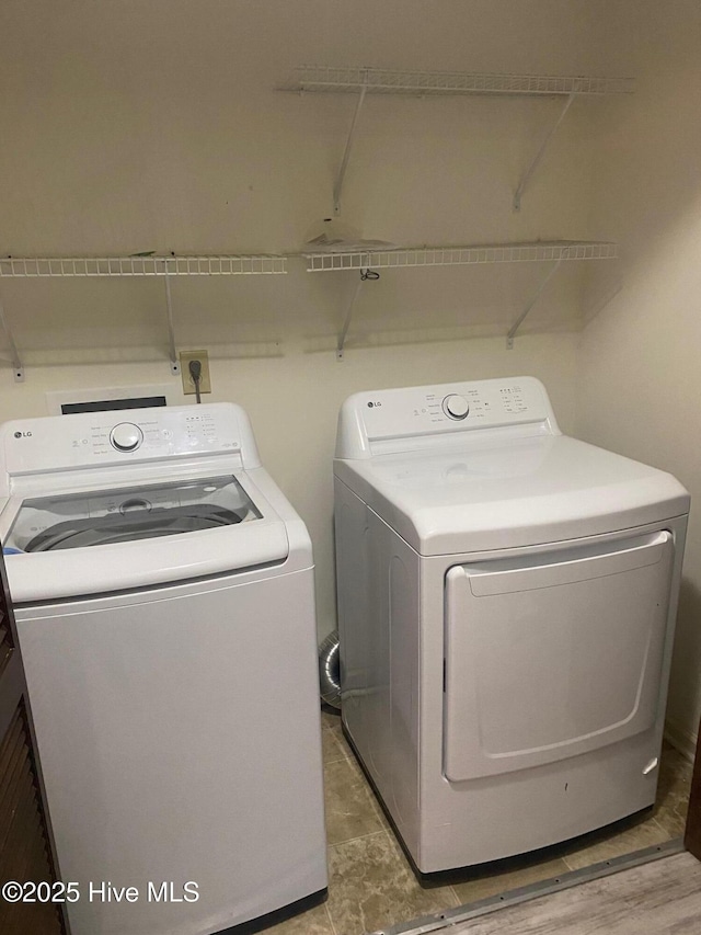 clothes washing area with laundry area and washing machine and clothes dryer