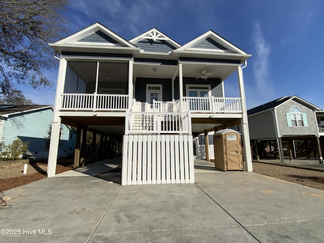 coastal home featuring driveway, stairway, and a carport