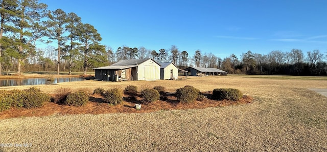 view of yard with a water view and a carport