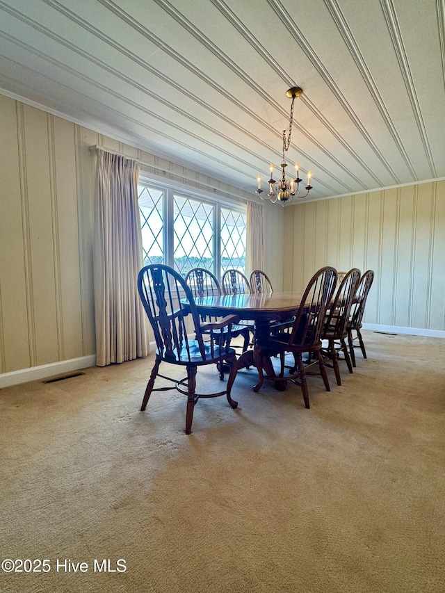 dining room featuring an inviting chandelier, visible vents, and light colored carpet