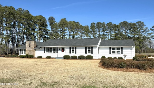 ranch-style home with a front lawn