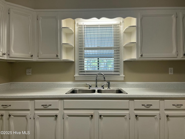 kitchen with white cabinetry, open shelves, and light countertops