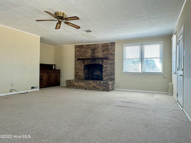 unfurnished living room with ornamental molding, a brick fireplace, and visible vents