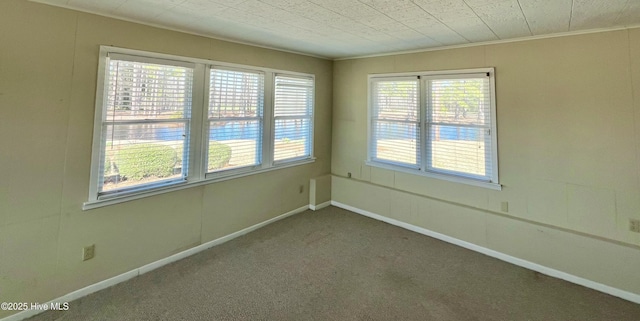 carpeted spare room with baseboards