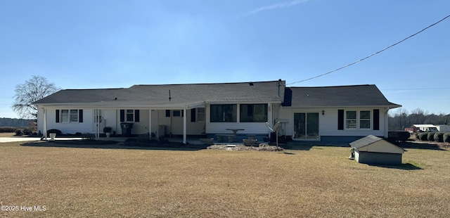 back of property featuring a yard and a patio area