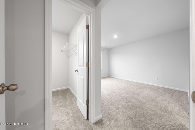 walk in closet featuring light carpet