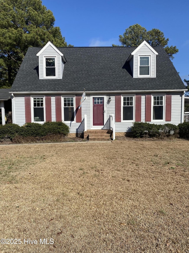 cape cod house featuring a front yard