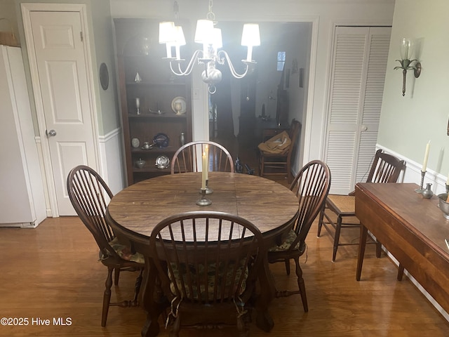 dining space featuring a notable chandelier and hardwood / wood-style flooring