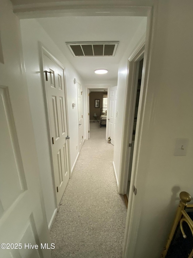 hallway featuring light carpet