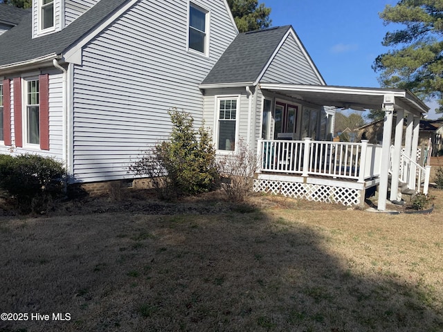 view of side of property with a yard and a porch