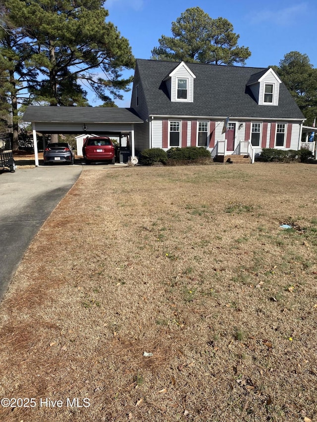 cape cod-style house with a front lawn and a carport