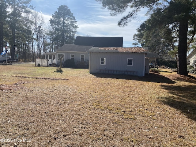 back of house with a lawn