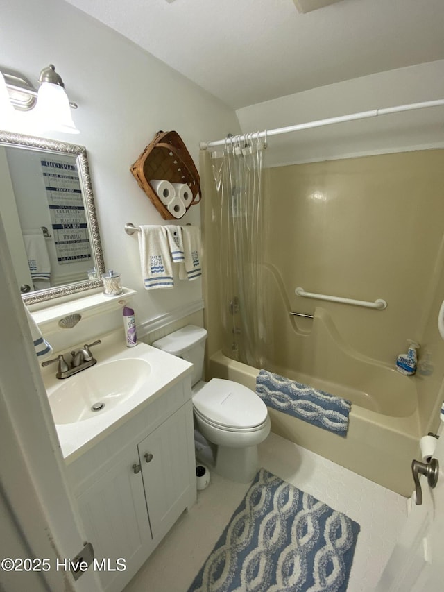 full bathroom with tile patterned floors, shower / bath combo with shower curtain, vanity, and toilet