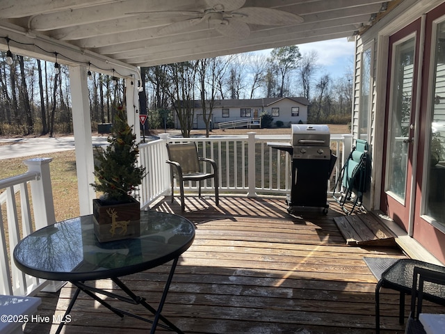 deck featuring grilling area and ceiling fan