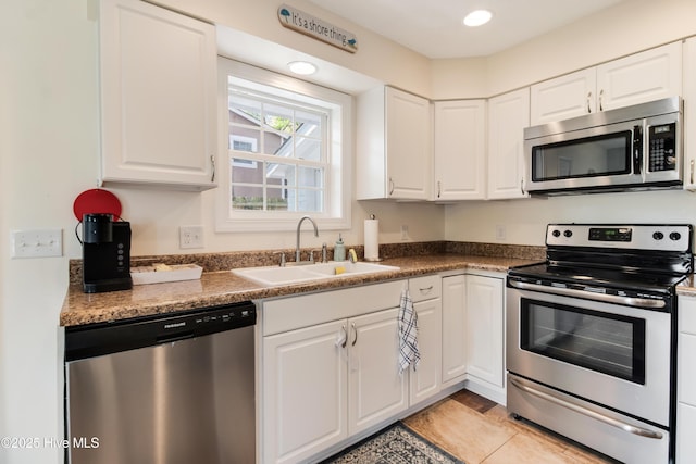 kitchen featuring white cabinetry, recessed lighting, appliances with stainless steel finishes, and a sink