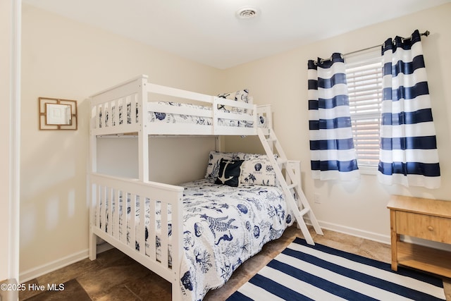 bedroom with visible vents and baseboards