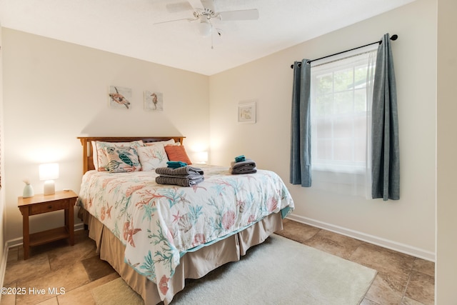 bedroom with baseboards and ceiling fan