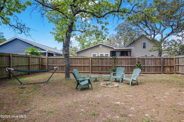 view of yard with a fire pit and a fenced backyard