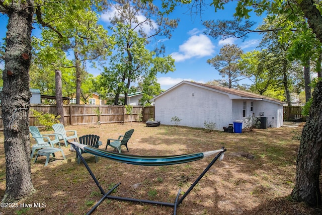 view of yard featuring cooling unit and fence