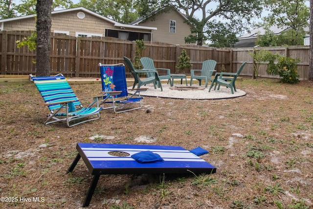 view of yard featuring an outdoor fire pit and fence