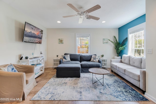 living area with recessed lighting, baseboards, and a ceiling fan