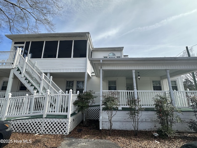 view of front of home with covered porch and a sunroom