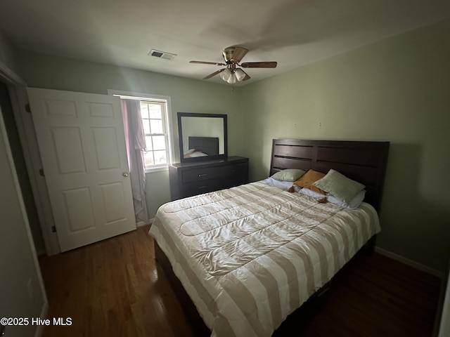 bedroom featuring ceiling fan and dark wood-type flooring