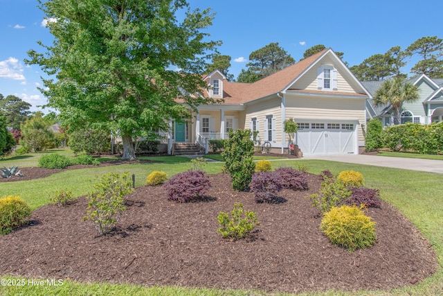 view of front of property with covered porch, a front yard, concrete driveway, and an attached garage