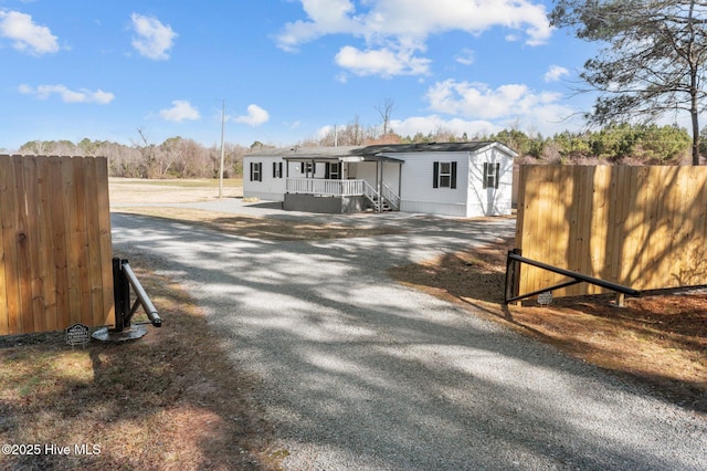view of front of house featuring driveway and fence