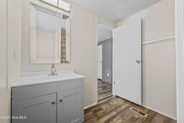 full bathroom featuring wood finished floors, vanity, and visible vents