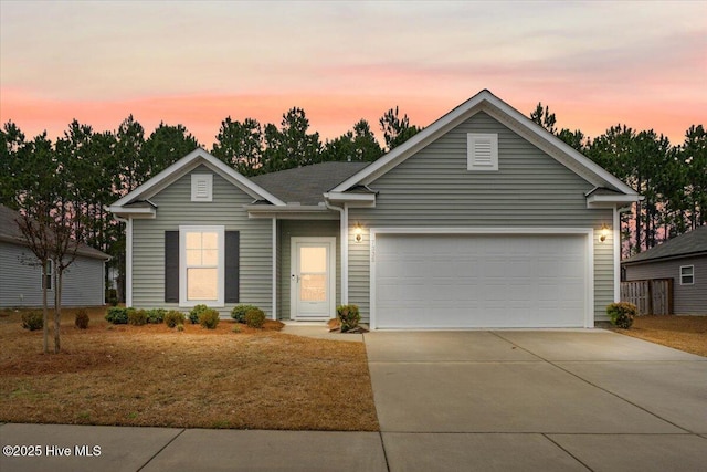 single story home with driveway and a garage