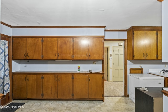 kitchen featuring crown molding and brown cabinetry