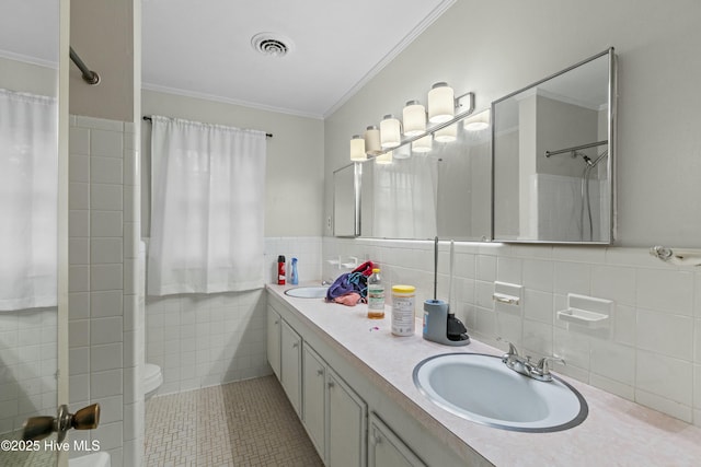 bathroom with tile walls, vanity, a shower, tile patterned floors, and ornamental molding