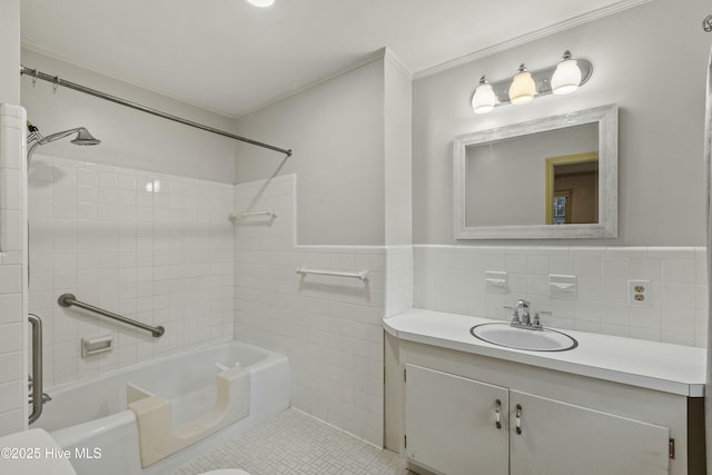 full bathroom with tile patterned floors, toilet, tile walls, vanity, and tiled shower / bath combo