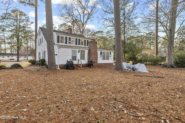 back of property featuring a chimney