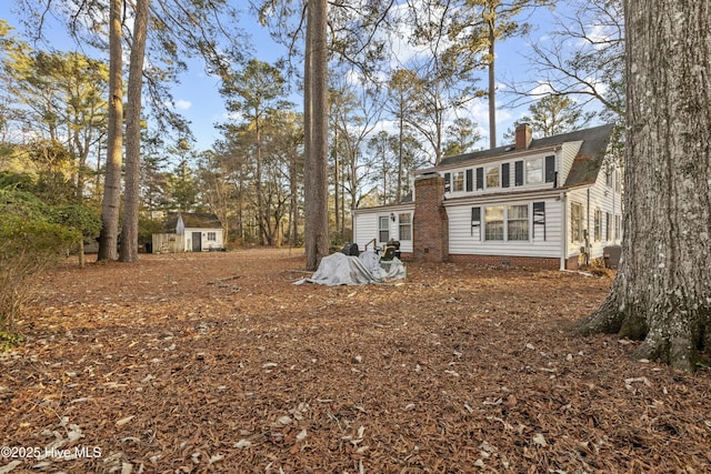 back of property with a storage unit