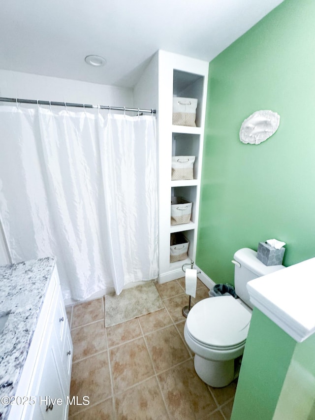 full bathroom with toilet, curtained shower, vanity, and tile patterned floors