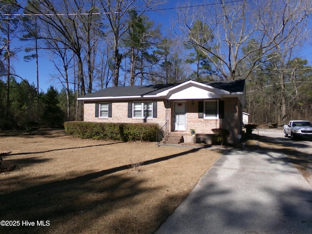 view of front facade featuring brick siding and covered porch