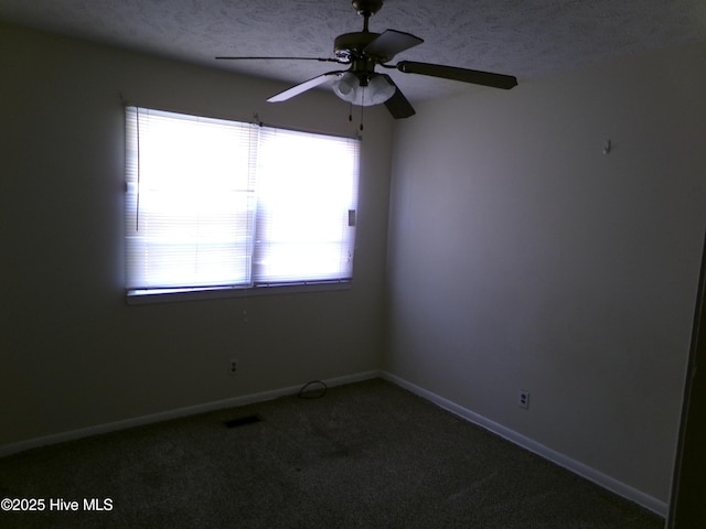 carpeted spare room with a textured ceiling, ceiling fan, and baseboards