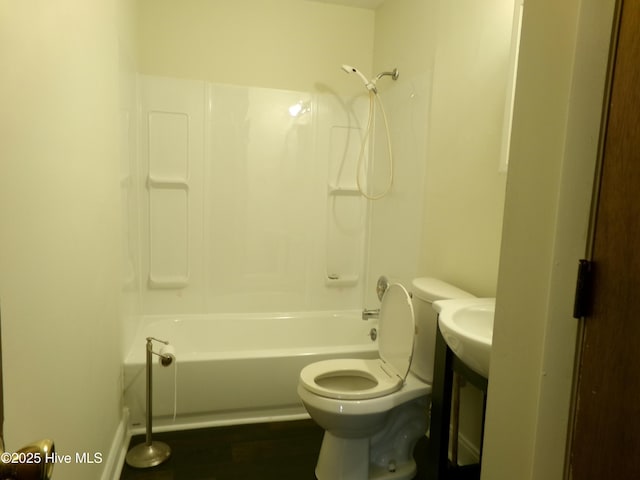 bathroom with wood finished floors, bathtub / shower combination, and toilet