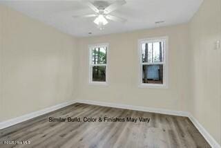 spare room with ceiling fan and wood-type flooring