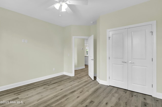 unfurnished bedroom featuring a closet, ceiling fan, and light hardwood / wood-style flooring