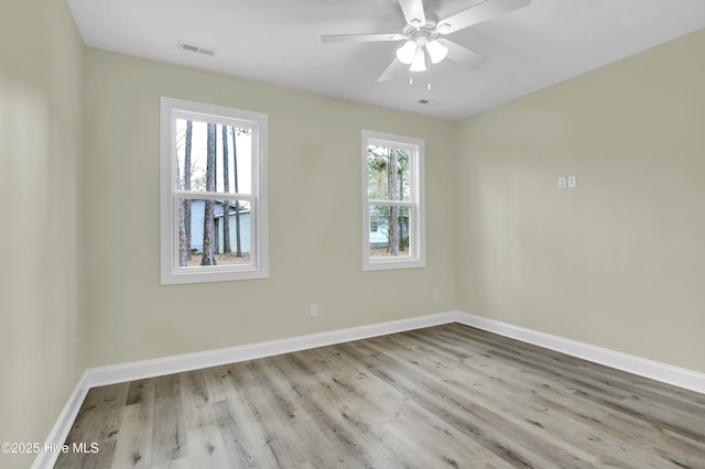 spare room featuring ceiling fan and light hardwood / wood-style flooring