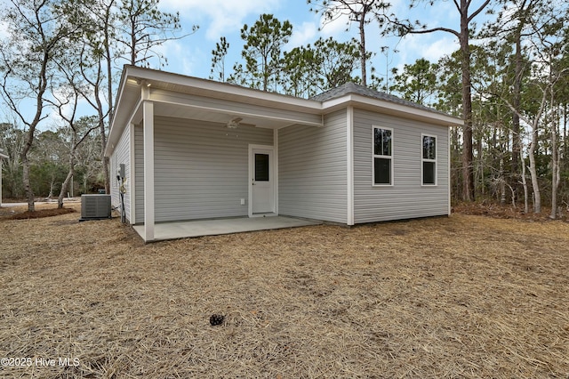 rear view of property with central AC unit and a patio area