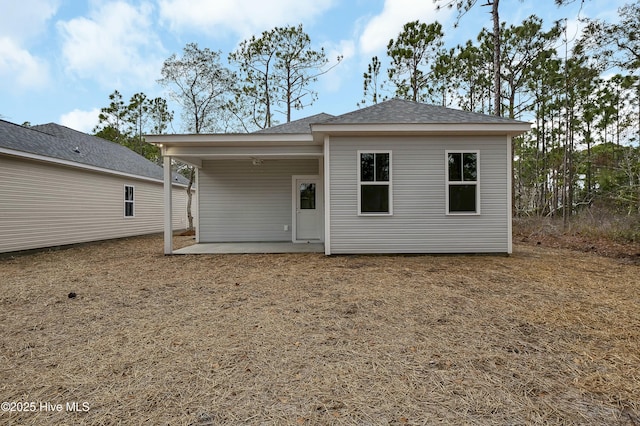 back of property with a patio