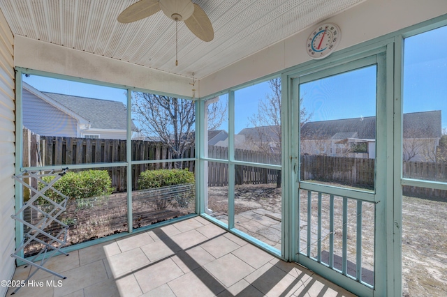 sunroom featuring ceiling fan