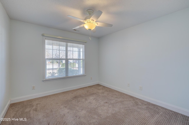 unfurnished room featuring visible vents, a ceiling fan, light colored carpet, and baseboards