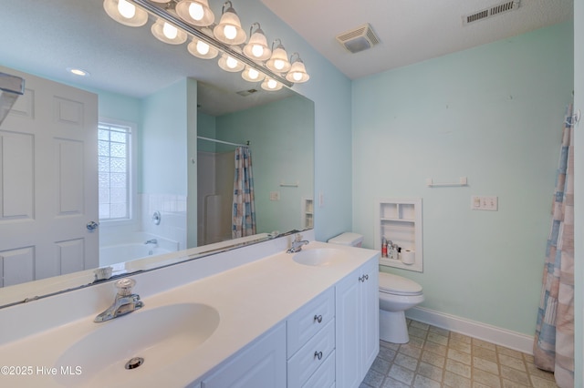 bathroom featuring toilet, a sink, and visible vents