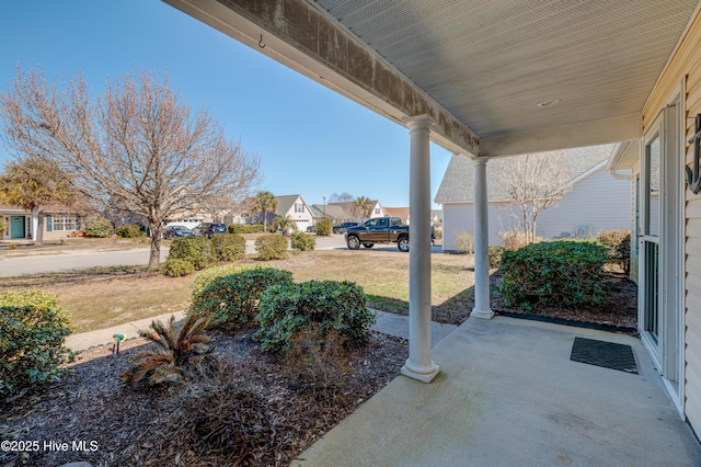 view of patio featuring a porch and a residential view