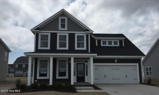 view of front of property with a porch and a garage